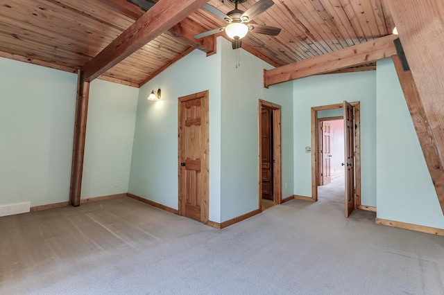 interior space featuring vaulted ceiling with beams, wood ceiling, baseboards, and carpet floors