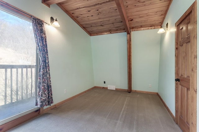 spare room featuring lofted ceiling with beams, baseboards, wooden ceiling, and carpet flooring