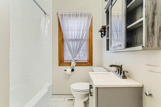 full bathroom featuring tile patterned floors, toilet, shower / tub combo with curtain, and vanity