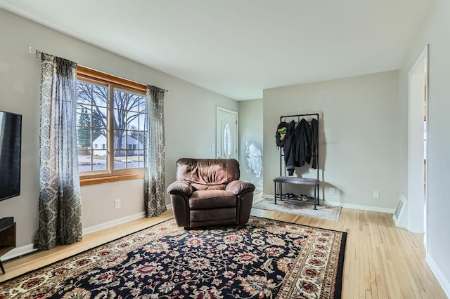 sitting room with wood finished floors and baseboards