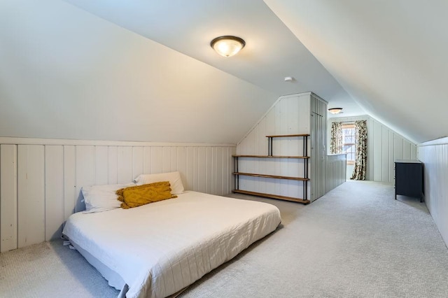 bedroom with lofted ceiling and light carpet