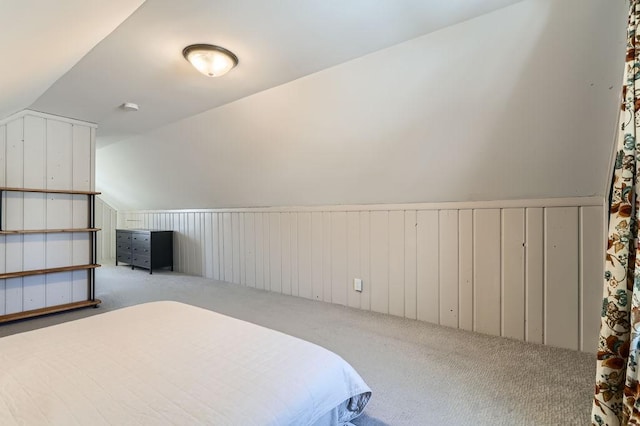 bedroom featuring lofted ceiling and carpet flooring