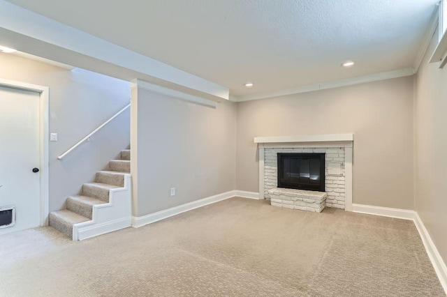 unfurnished living room with carpet, baseboards, recessed lighting, stairs, and a glass covered fireplace