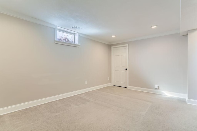 below grade area with light colored carpet, crown molding, and baseboards