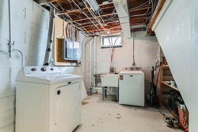 laundry room featuring laundry area, electric panel, separate washer and dryer, and a sink