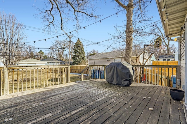 deck with area for grilling and fence