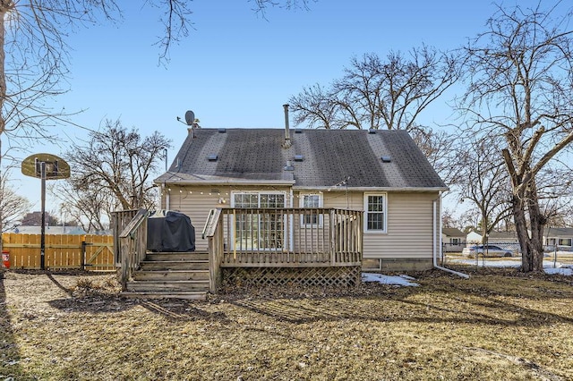 back of house featuring a gate, a wooden deck, and fence