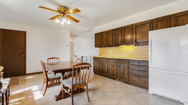 dining area featuring baseboards and a ceiling fan