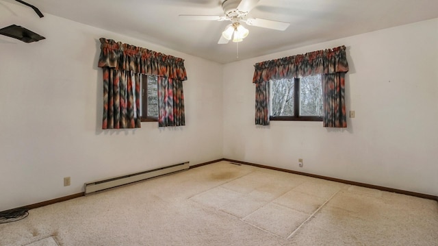 empty room with ceiling fan, a baseboard heating unit, and baseboards