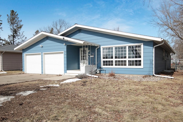 ranch-style house with a garage and concrete driveway