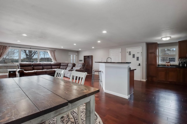 dining area with recessed lighting, baseboards, and dark wood finished floors