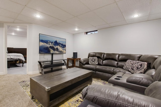 carpeted living area featuring a drop ceiling, recessed lighting, and baseboards