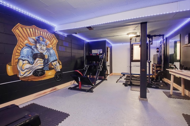 workout room featuring concrete block wall