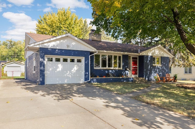 ranch-style home with an attached garage, a chimney, concrete driveway, a front lawn, and brick siding