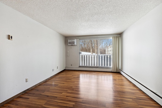 spare room featuring wood finished floors, baseboards, a baseboard radiator, a wall mounted air conditioner, and a textured ceiling