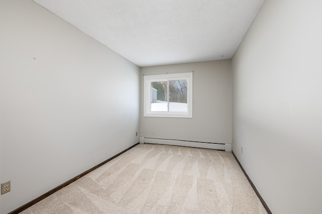 unfurnished room with light colored carpet, a textured ceiling, baseboards, and a baseboard radiator