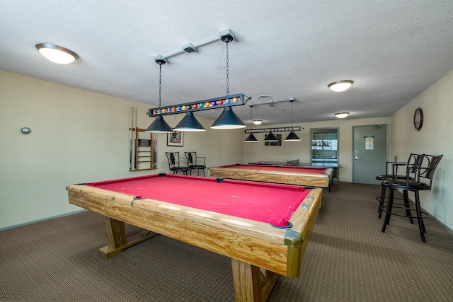 recreation room with pool table, carpet floors, and a textured ceiling