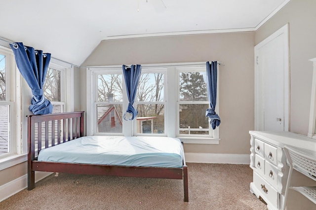 bedroom with light colored carpet, lofted ceiling, and baseboards