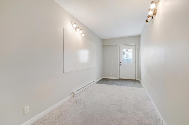 carpeted entrance foyer with a baseboard heating unit and baseboards