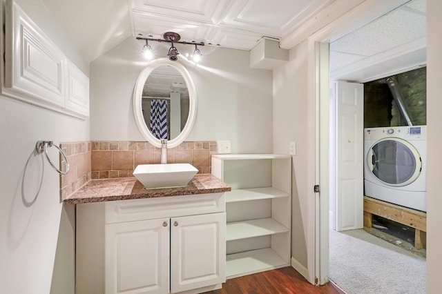 full bathroom featuring vanity and washer / dryer