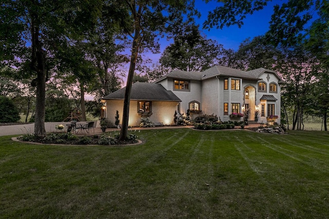 french country style house with a front yard