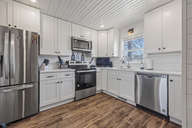 kitchen with a sink, appliances with stainless steel finishes, white cabinets, and light countertops