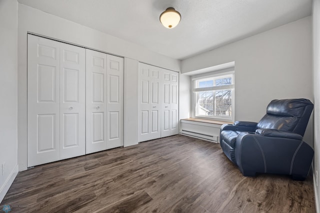 sitting room featuring a baseboard radiator and dark wood-type flooring