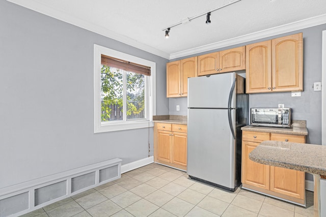 kitchen featuring visible vents, light brown cabinetry, appliances with stainless steel finishes, crown molding, and light tile patterned floors