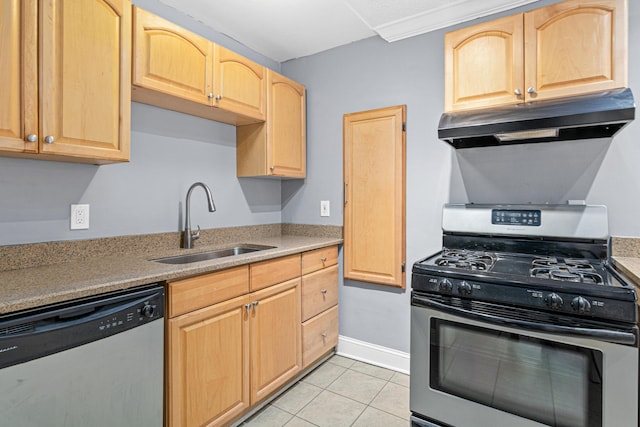 kitchen featuring under cabinet range hood, appliances with stainless steel finishes, light brown cabinetry, and a sink