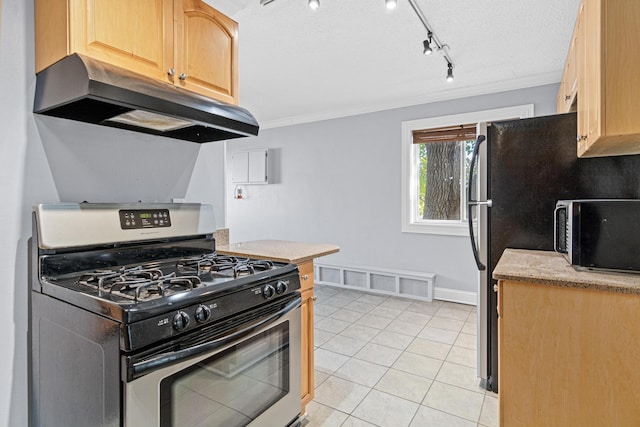 kitchen featuring crown molding, under cabinet range hood, light countertops, light tile patterned floors, and gas stove