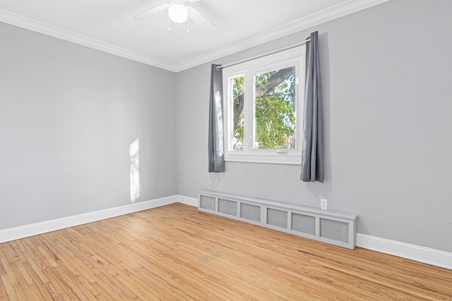 unfurnished room with ornamental molding, a ceiling fan, baseboards, and wood finished floors