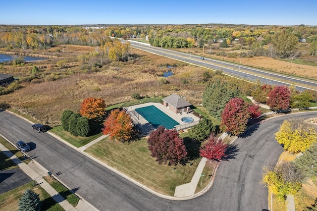 bird's eye view with a forest view and a water view