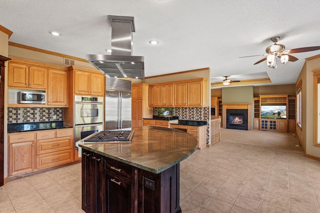 kitchen featuring tasteful backsplash, open floor plan, a center island, stainless steel appliances, and island range hood