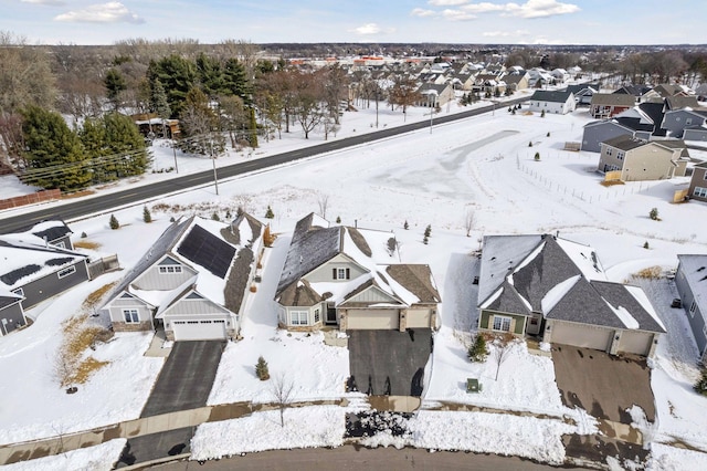 snowy aerial view featuring a residential view