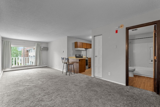 living room featuring baseboards, light carpet, a textured ceiling, and a wall mounted AC