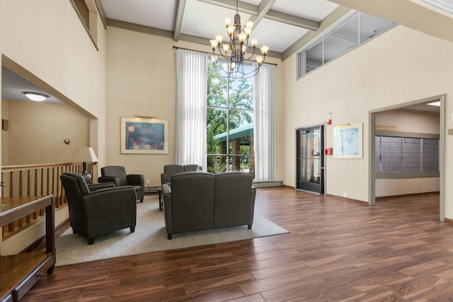 living area featuring beam ceiling, a high ceiling, and wood finished floors