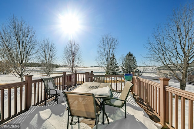 snow covered deck with outdoor dining area