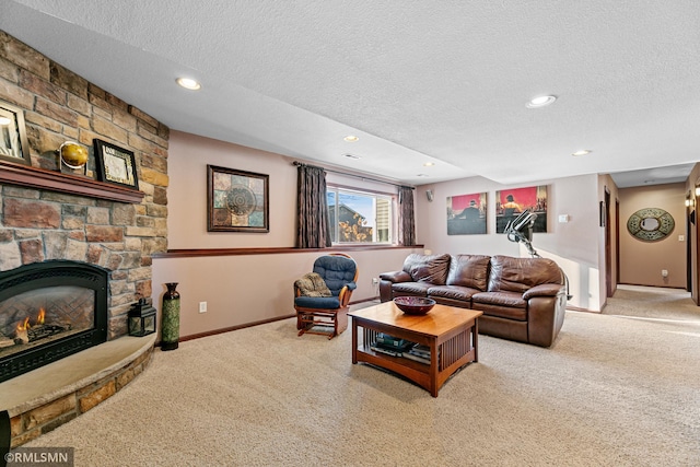 living area featuring recessed lighting, a fireplace, a textured ceiling, and carpet