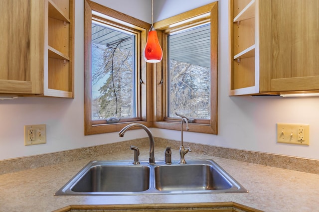 kitchen featuring light countertops and a sink