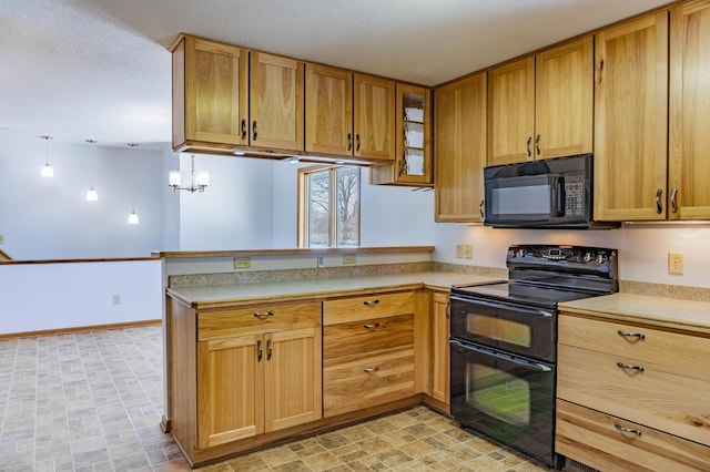 kitchen featuring baseboards, a peninsula, black appliances, light countertops, and glass insert cabinets