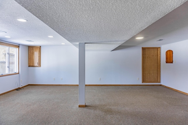 below grade area with recessed lighting, baseboards, carpet, and a textured ceiling