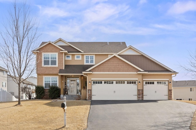 view of front of home with stone siding, a garage, driveway, and a shingled roof