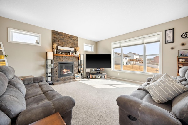 carpeted living area with a fireplace and baseboards