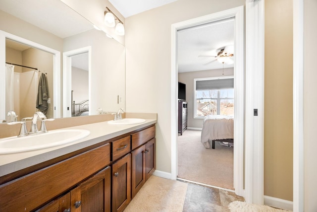 bathroom featuring a sink, double vanity, and connected bathroom