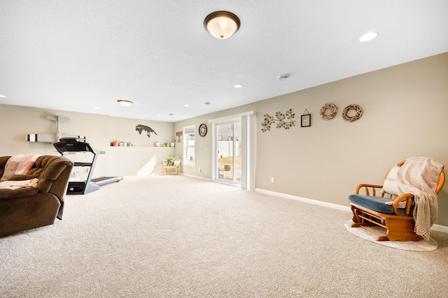 sitting room featuring recessed lighting, a textured ceiling, baseboards, and carpet