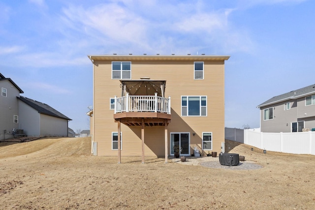 back of house with central AC unit, a wooden deck, and fence