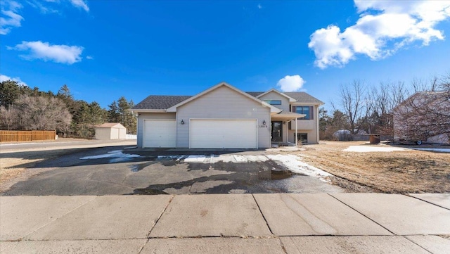 view of front of property featuring a garage and fence