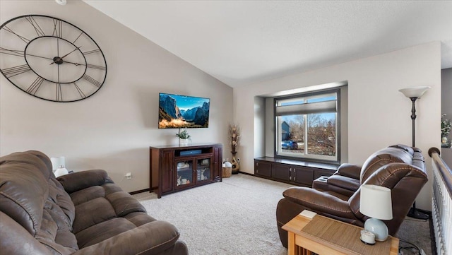 living area featuring lofted ceiling, baseboards, and light carpet