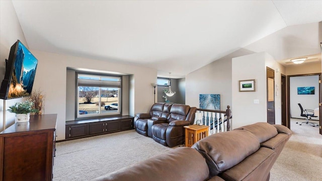 carpeted living area with lofted ceiling