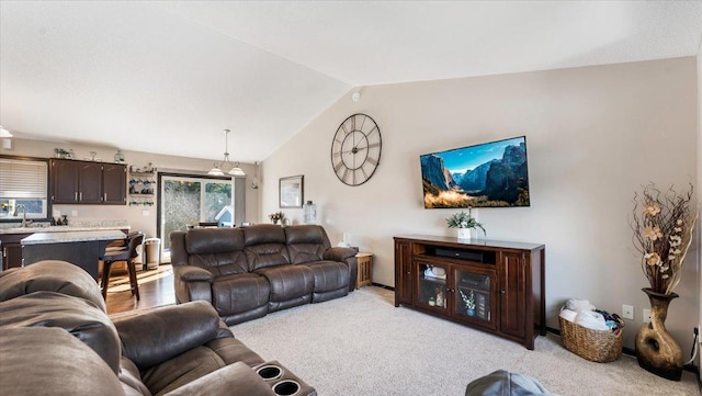 living area featuring lofted ceiling and light colored carpet